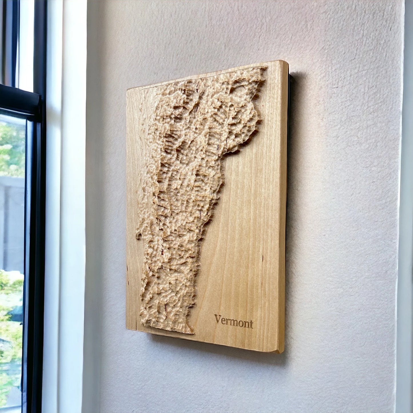 Wooden relief map of Vermont on a wall