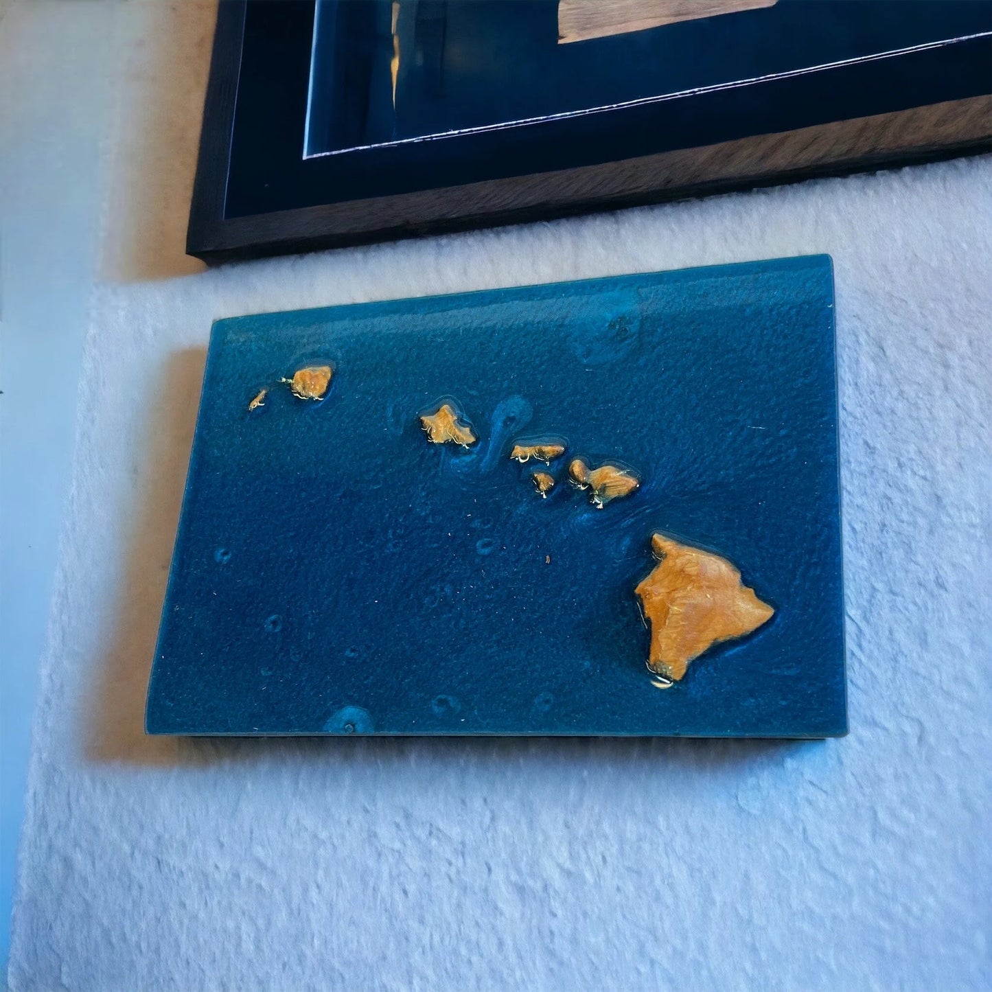 Hawaiian islands topographic map with Blue epoxy on a white surface