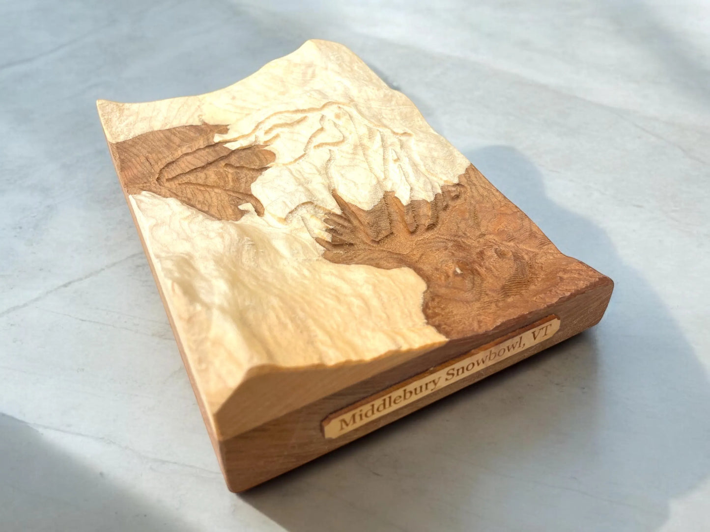 3D Wooden block of Middlebury Snow Bowl ski mountain on a light gray background