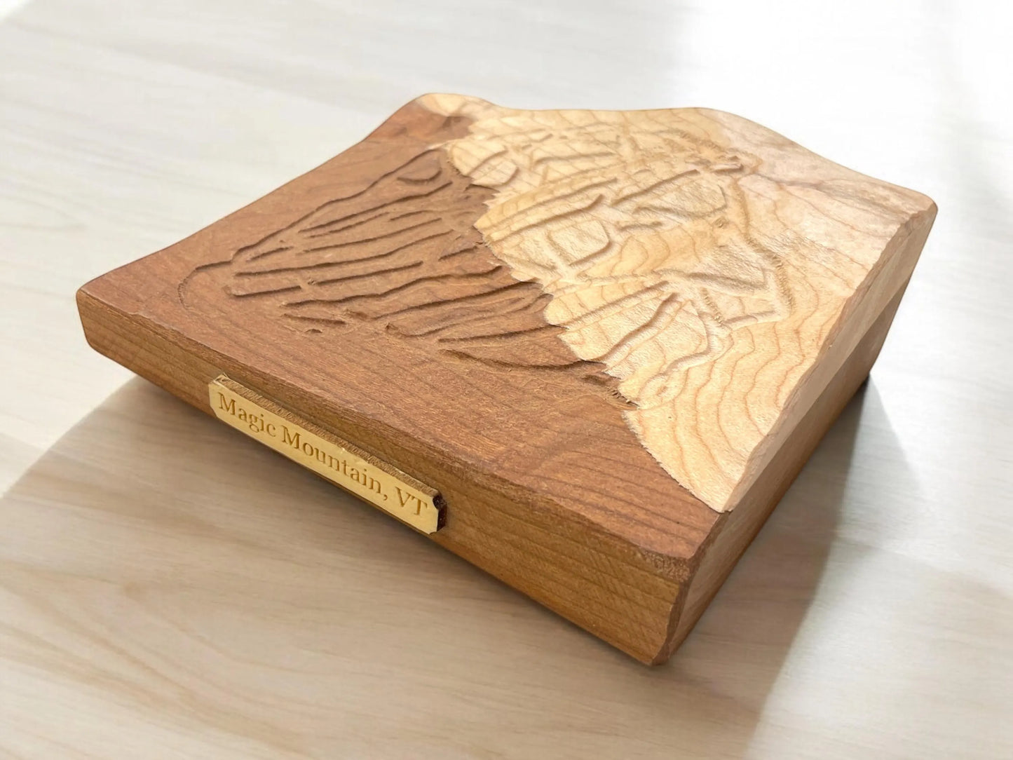 magic Mouintain ski resort carved in Wood with laser-cut design and 'Magic Mountain, VT' engraving on a white background