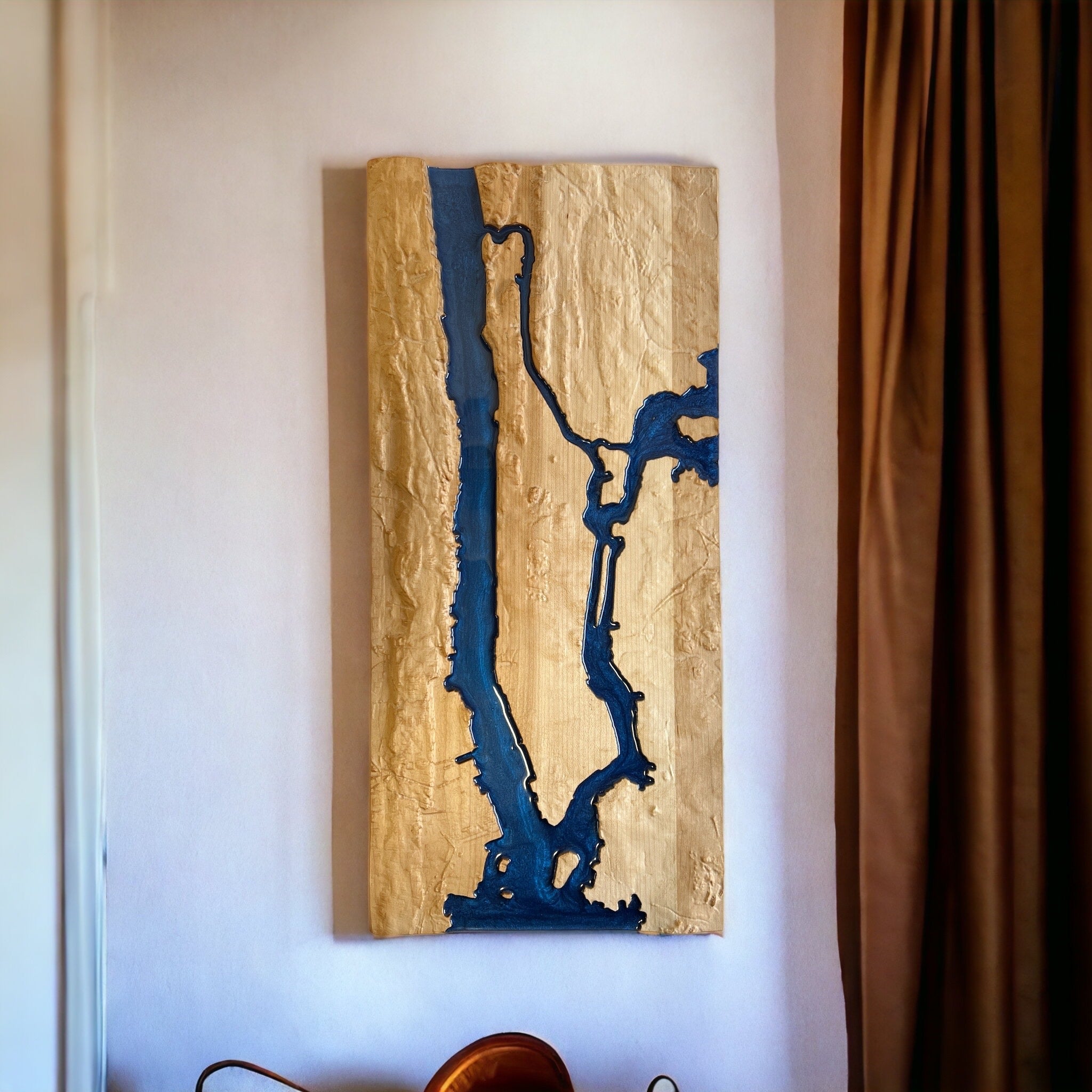 topo map of manhatton new york carved in wood hanging on a white wall