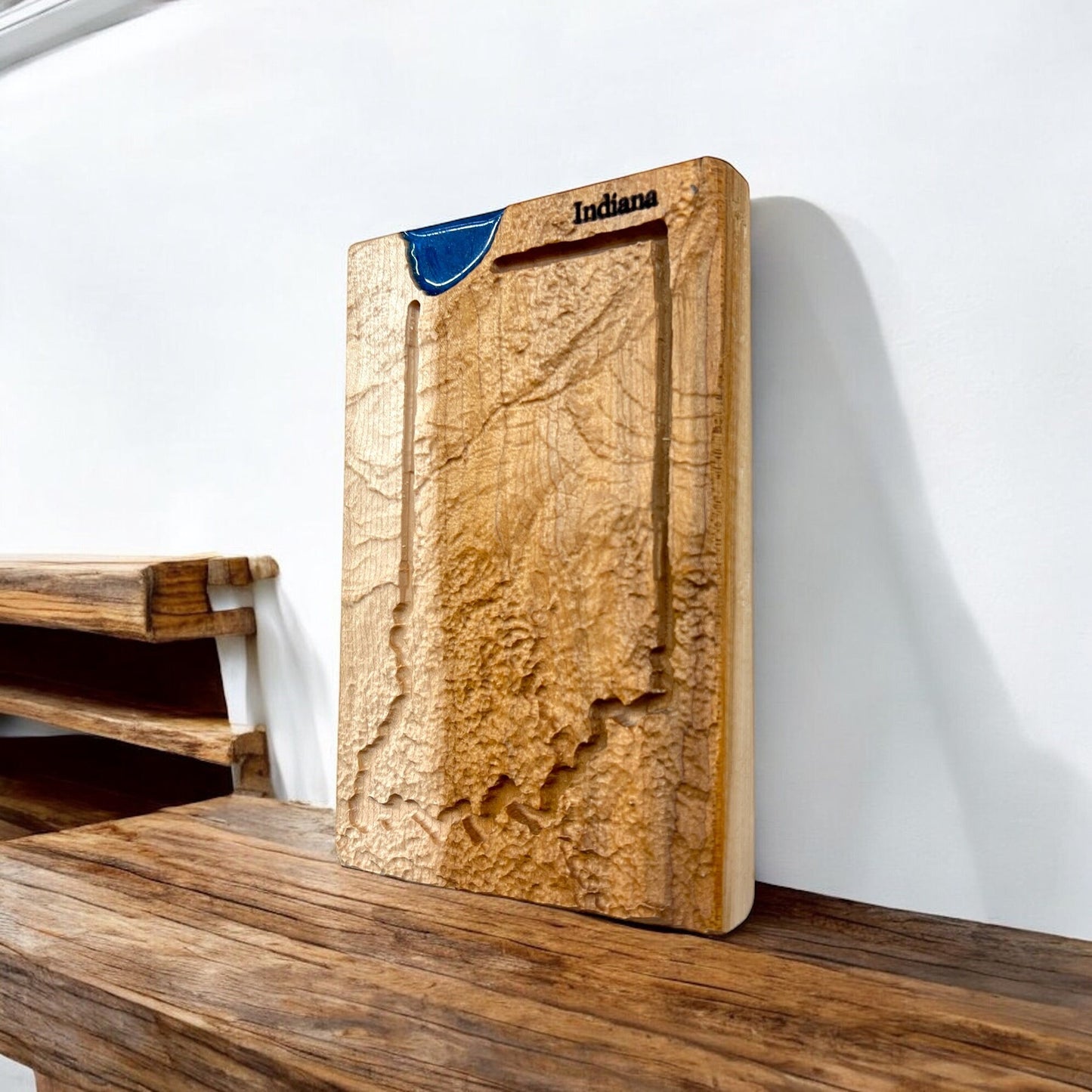 indiana wooden topo map with a raised map design of Indiana on a wooden surface.