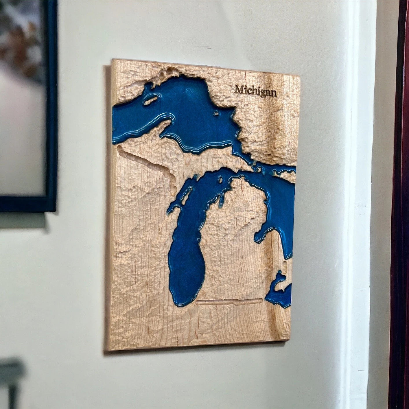 Wooden wall art of a topographic map of Michigan with blue water