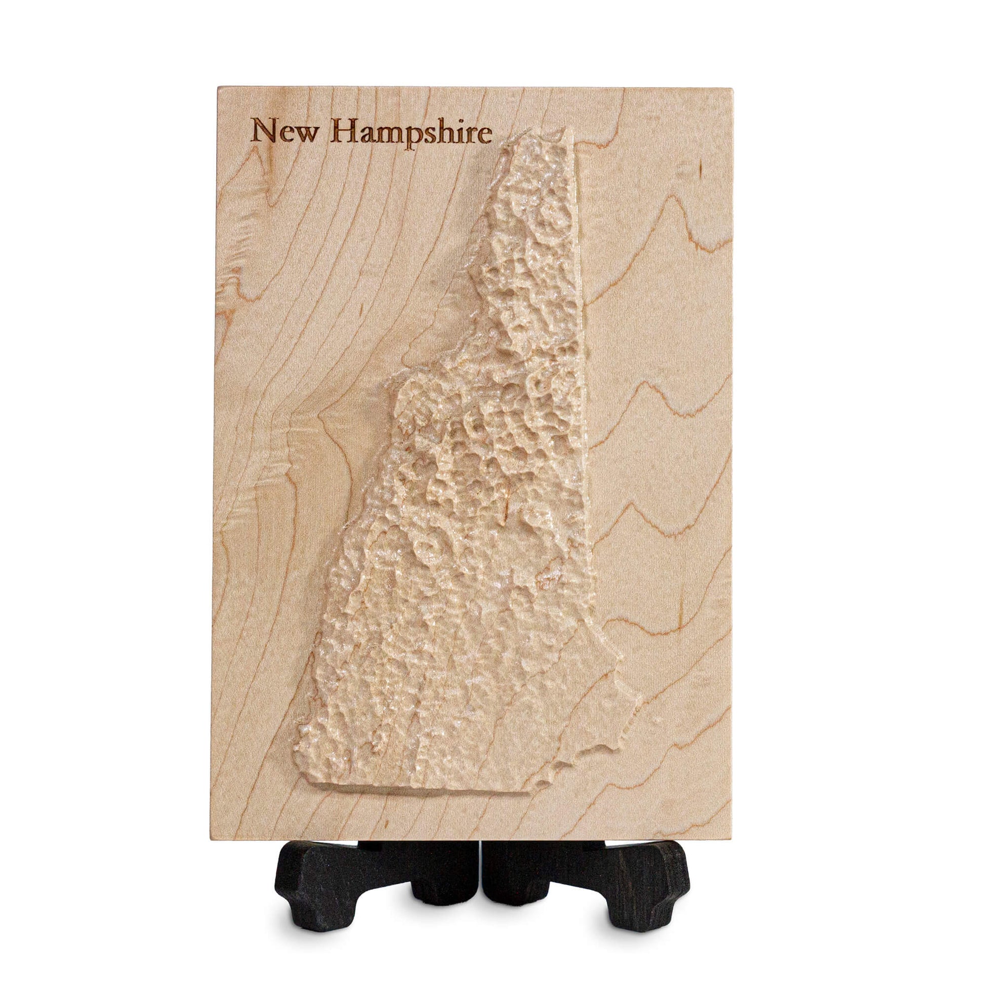 carved wooden map of new hampshire on a laser cut wooden display stand