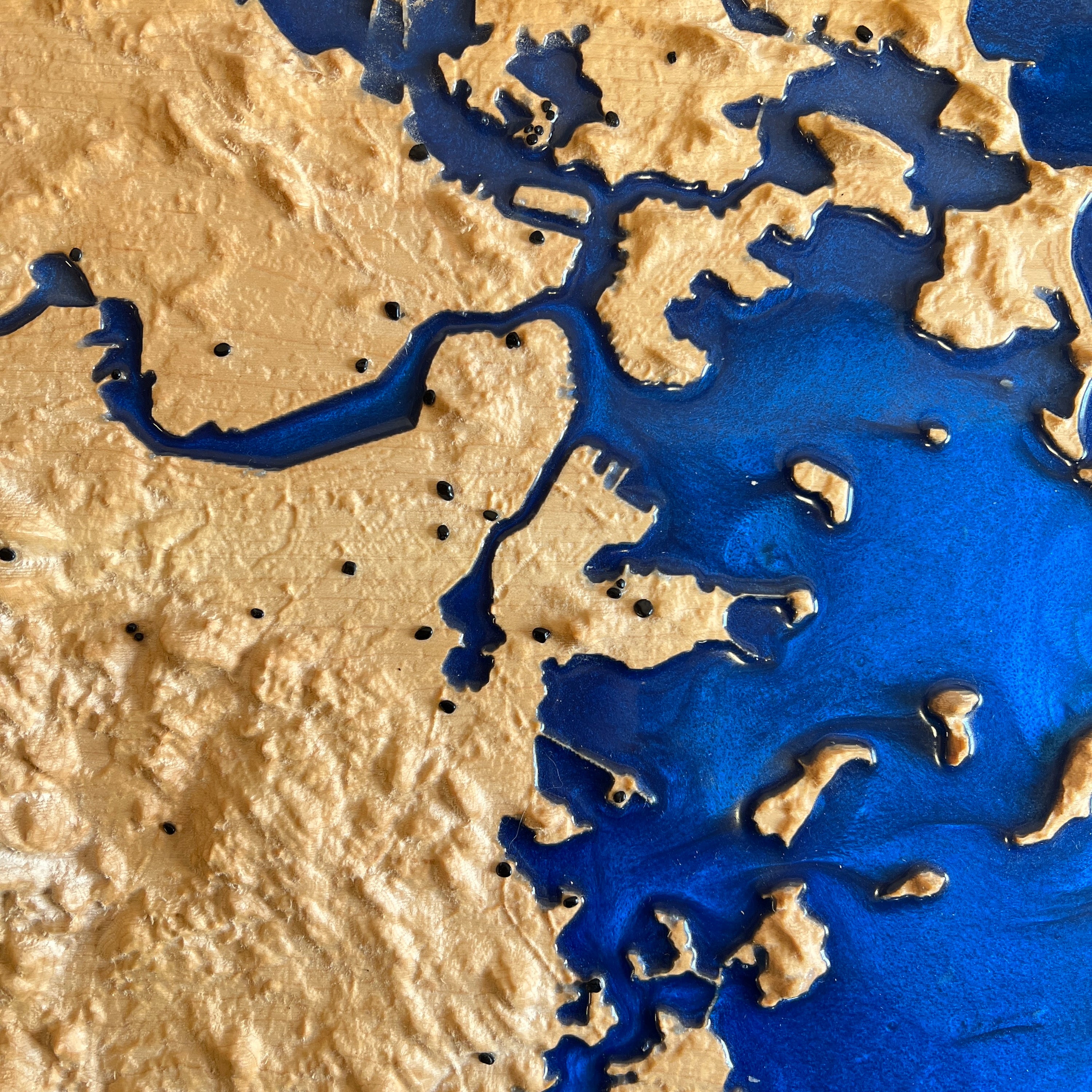 Harbor_close-up_with_gemstone_location_markers on a 3d wooden topo map