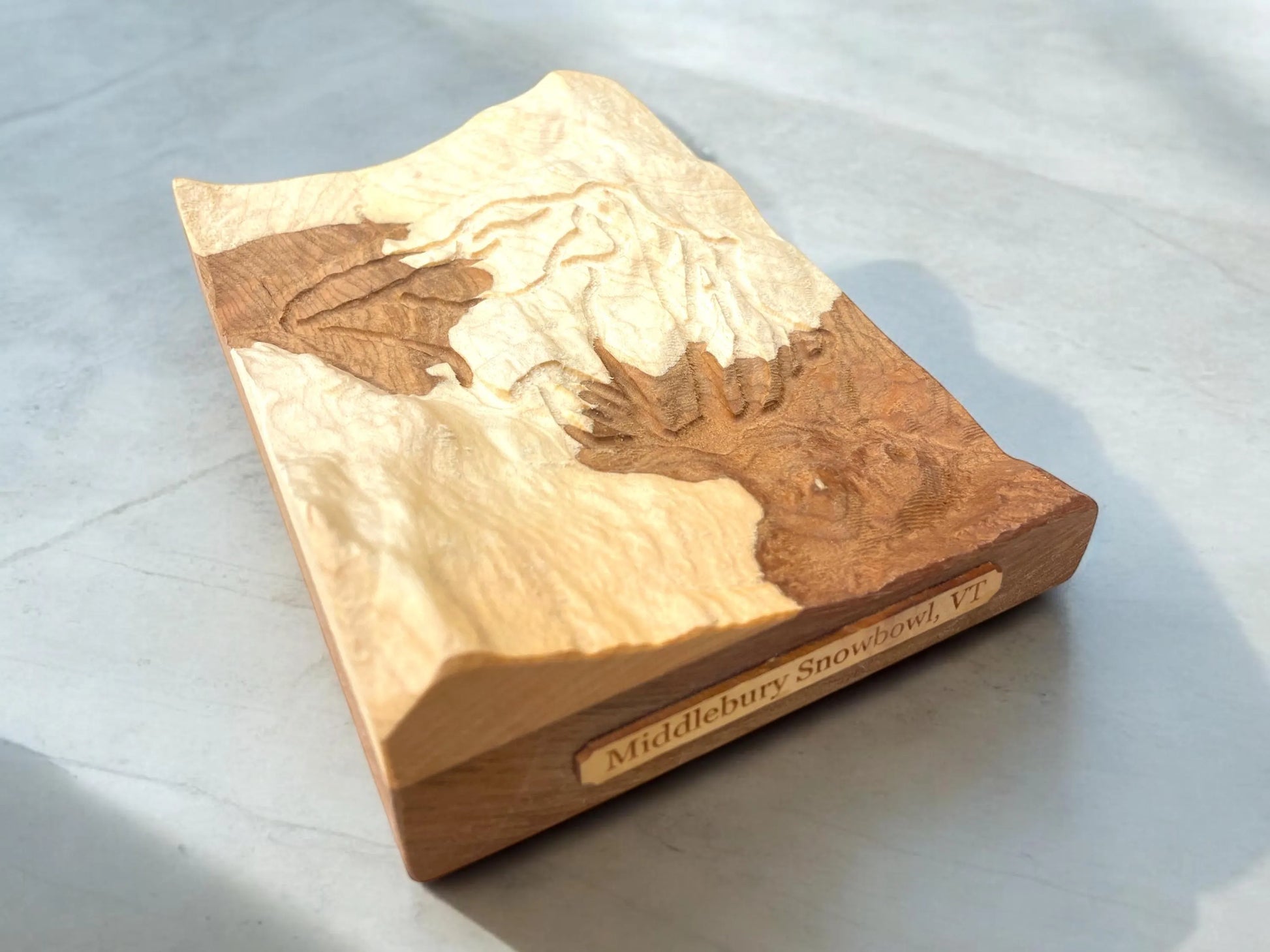 3D Wooden block of Middlebury Snow Bowl ski mountain on a light gray background