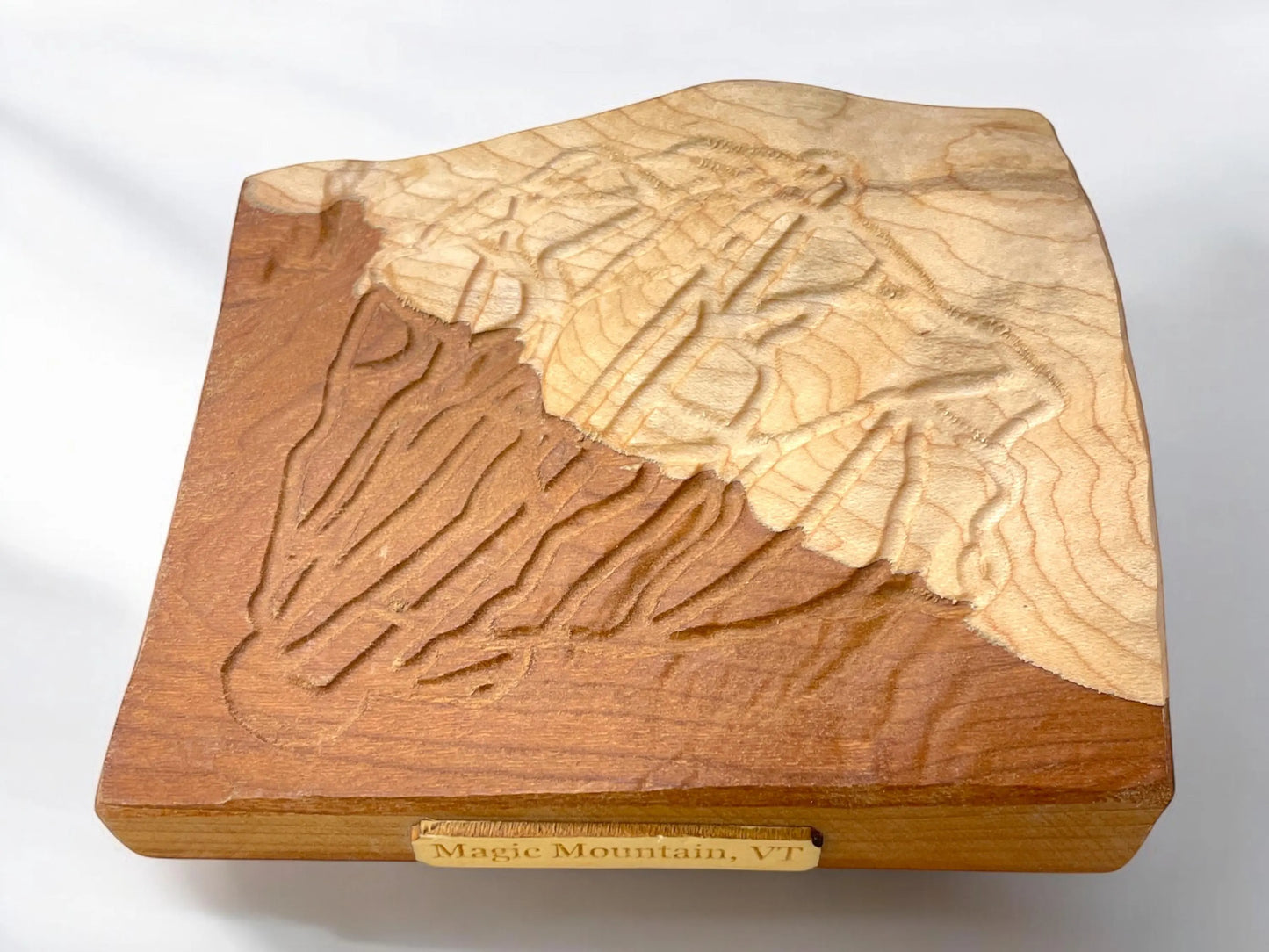 3D Wooden topographic carving  and 'Magic Mountain, Vt.' plaque inscription on a white background