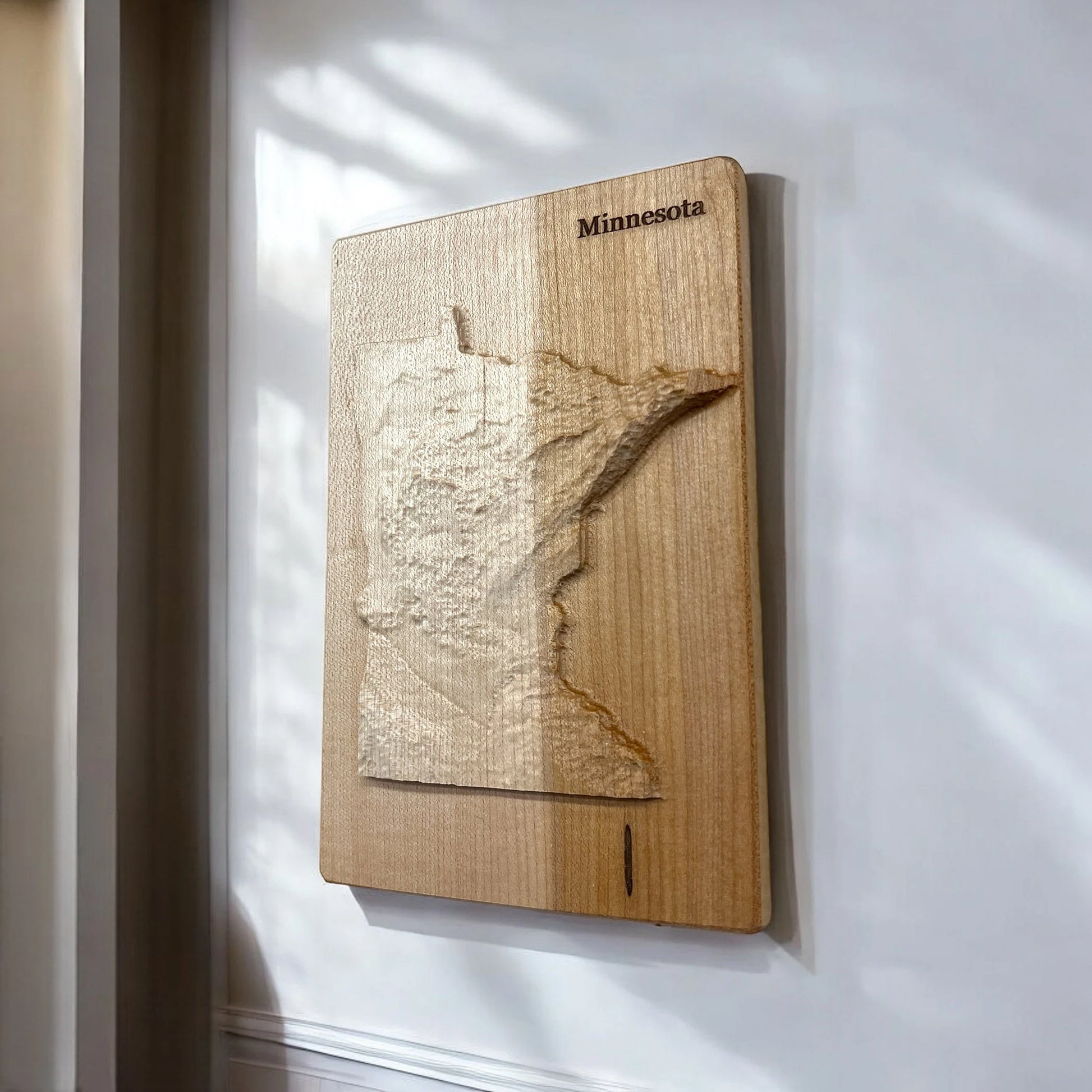 Wooden map wall art of Minnesota on a white wall