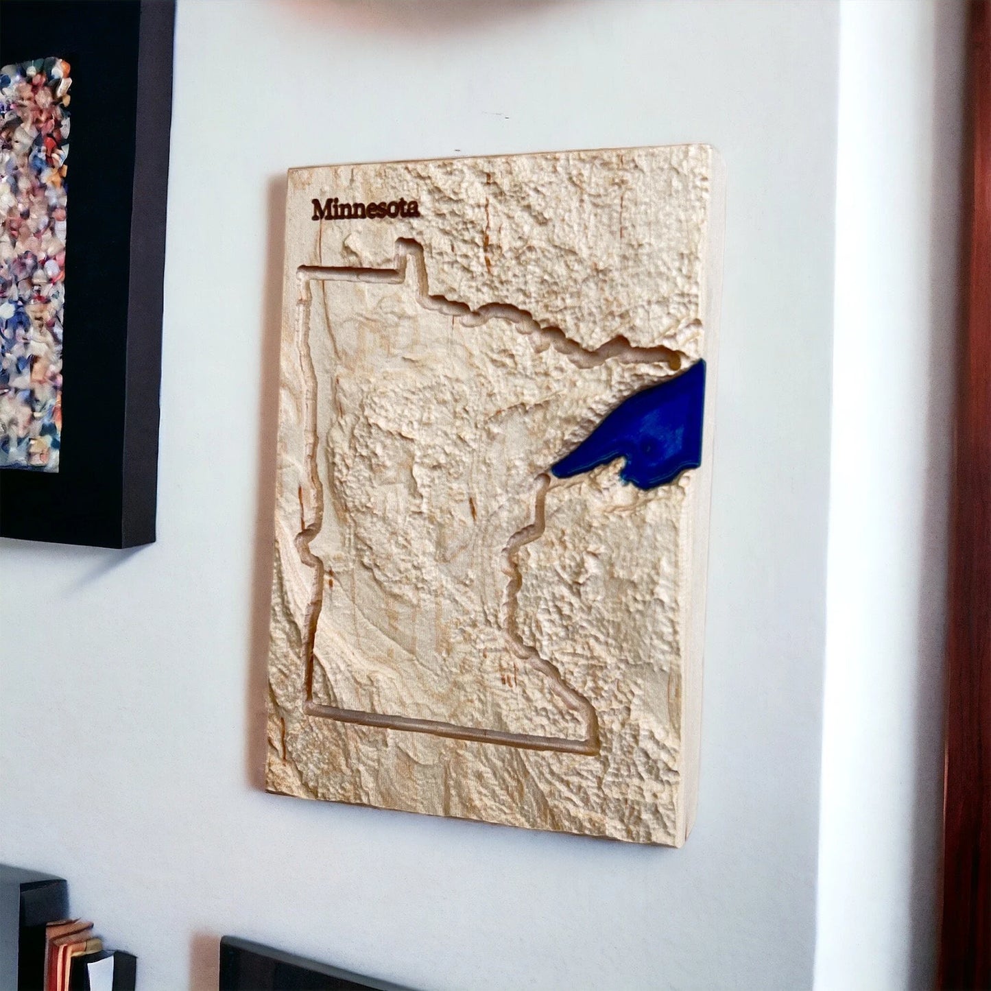 Wooden topo map of Minnesota on a wall