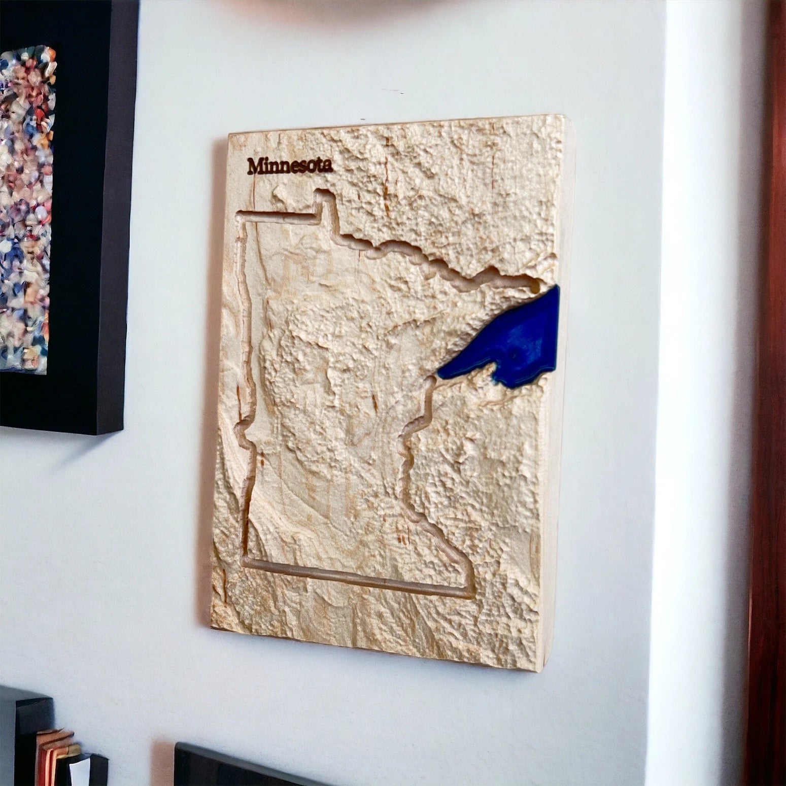 Wooden topo map of Minnesota on a wall