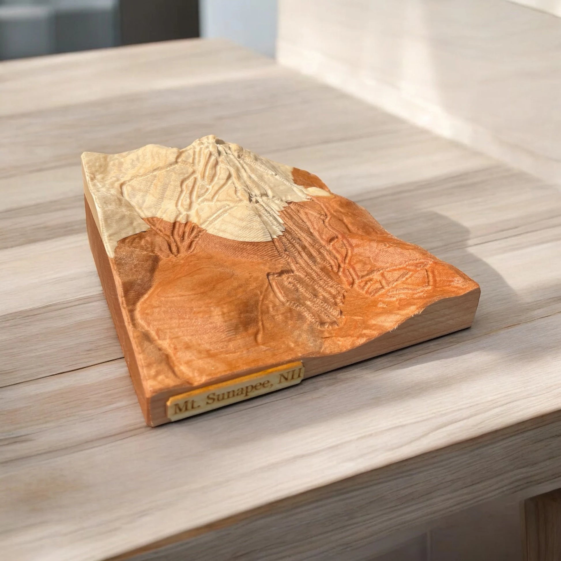 3D Wooden model of Sunapee Ski mountain on a wooden surface