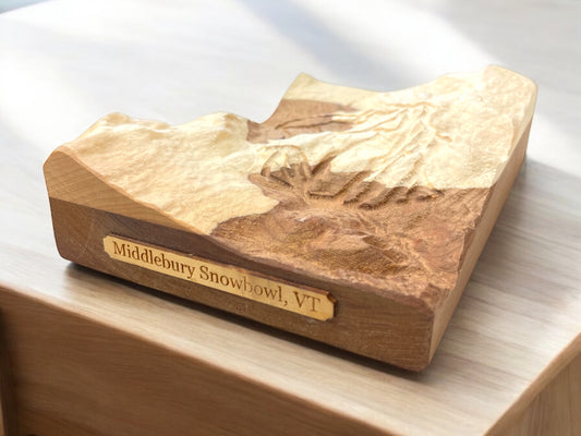 A wooden 3D relief model of a ski map, with 'Middlebury Snowbowl, VT' engraved on the side.