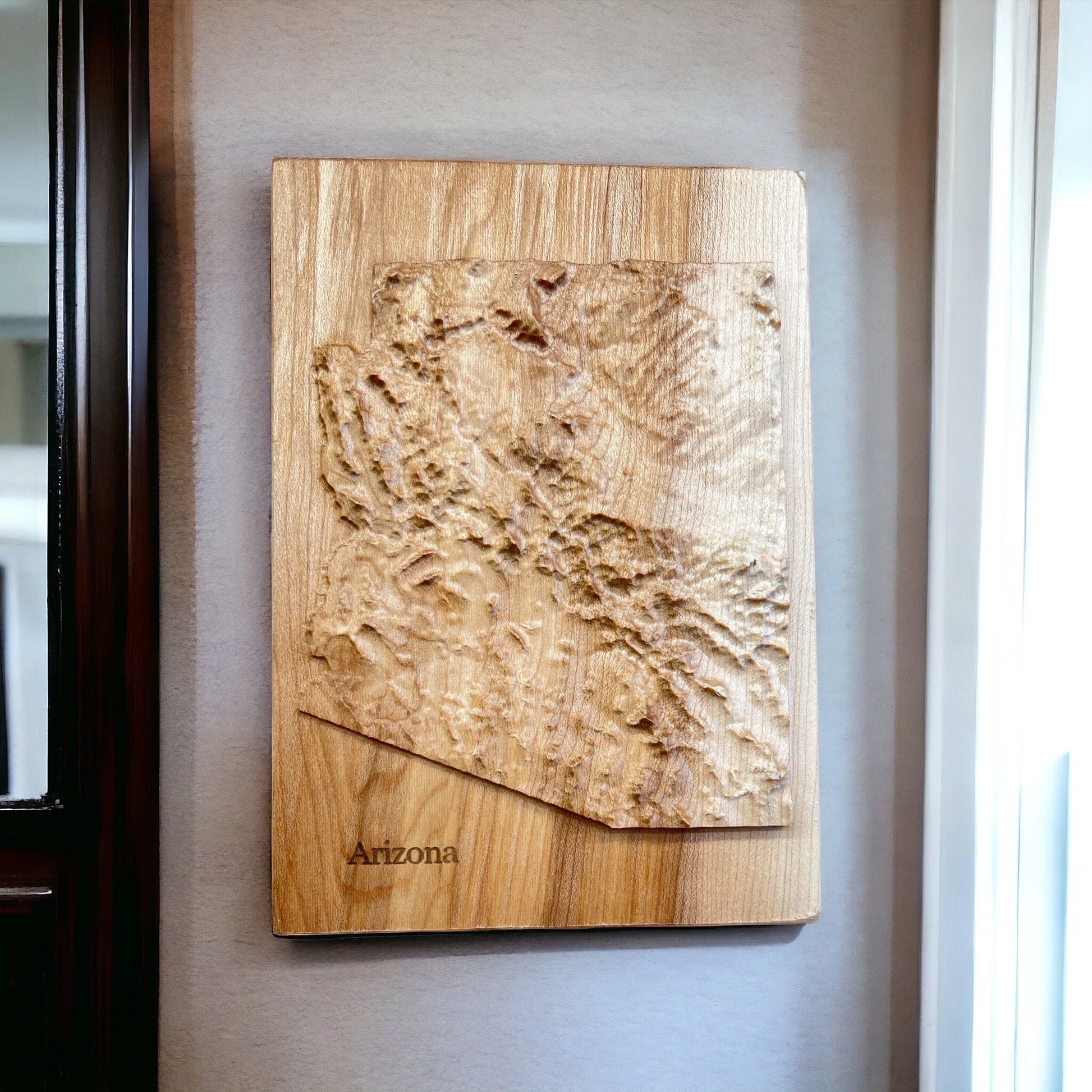 Wooden wall art of Arizona's topography on a neutral wall.