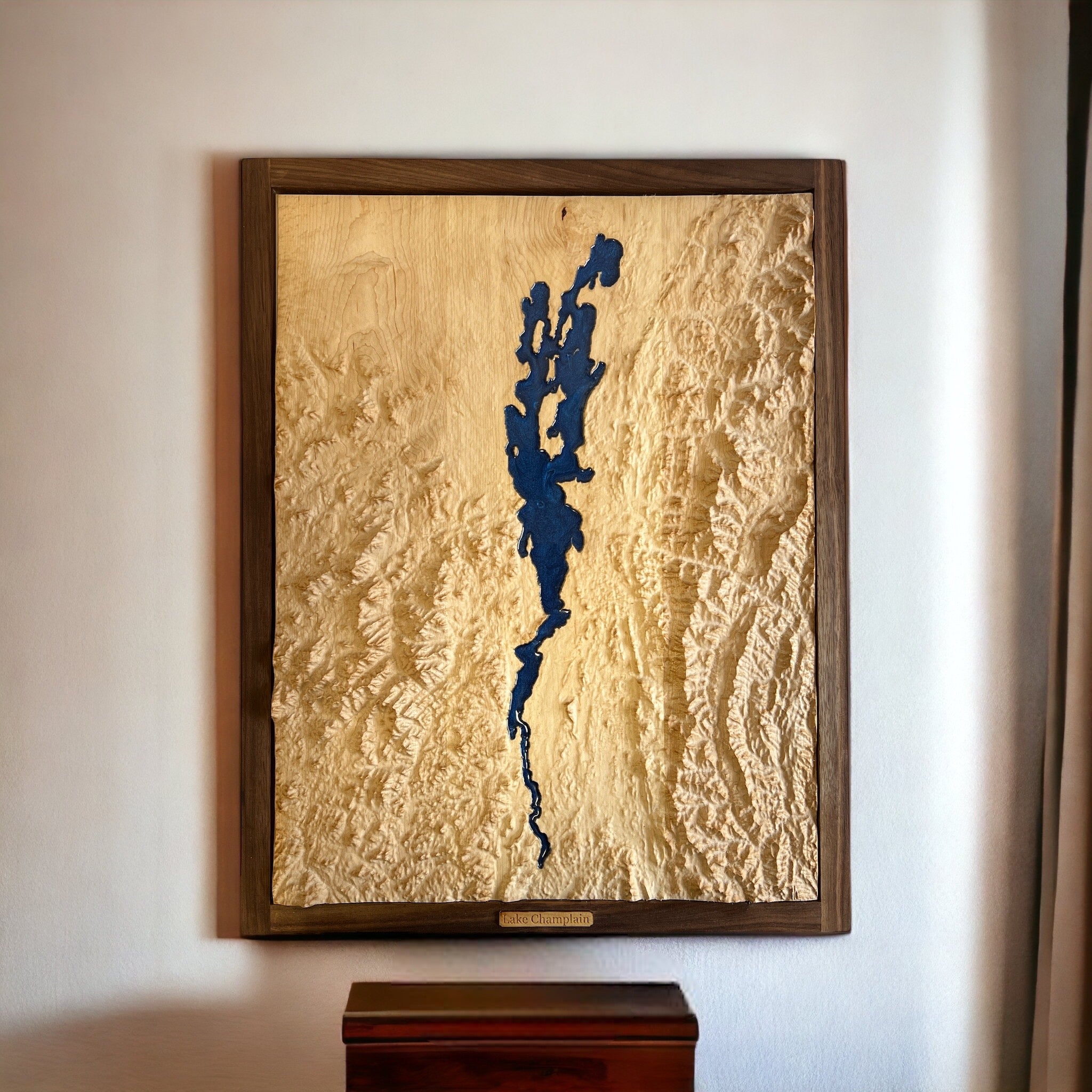 lake champlain with appalachian and green mountains topo wooden map framed and hanging on a white wall