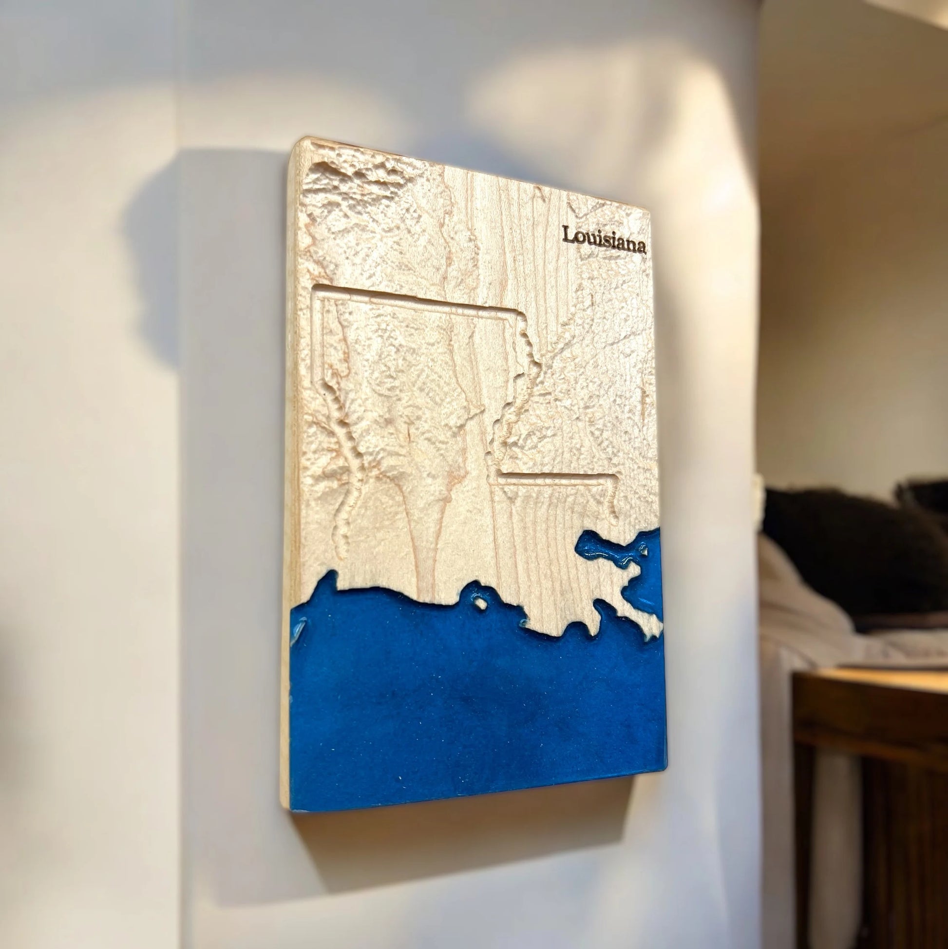 3D map of Louisiana with blue water detail on a white wall