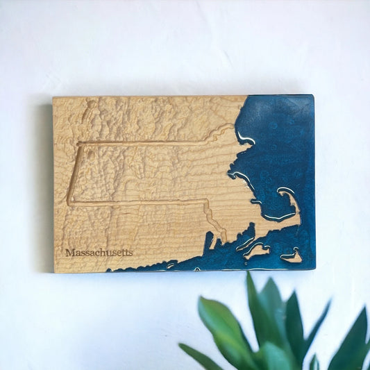 Wooden plaque with a map of Massachusetts on a white background