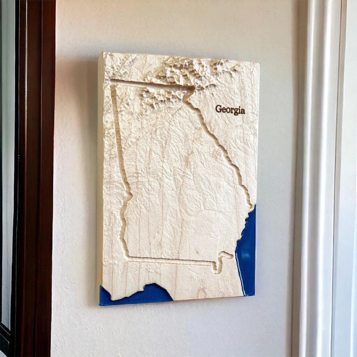 3D wall art of Georgia with blue accent of water on a white wall