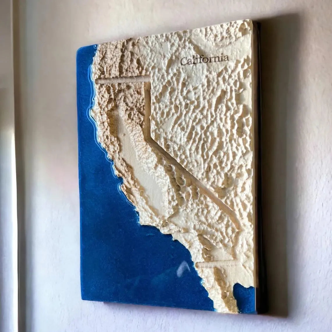 3D map of California with topographically textured surface and blue ocean