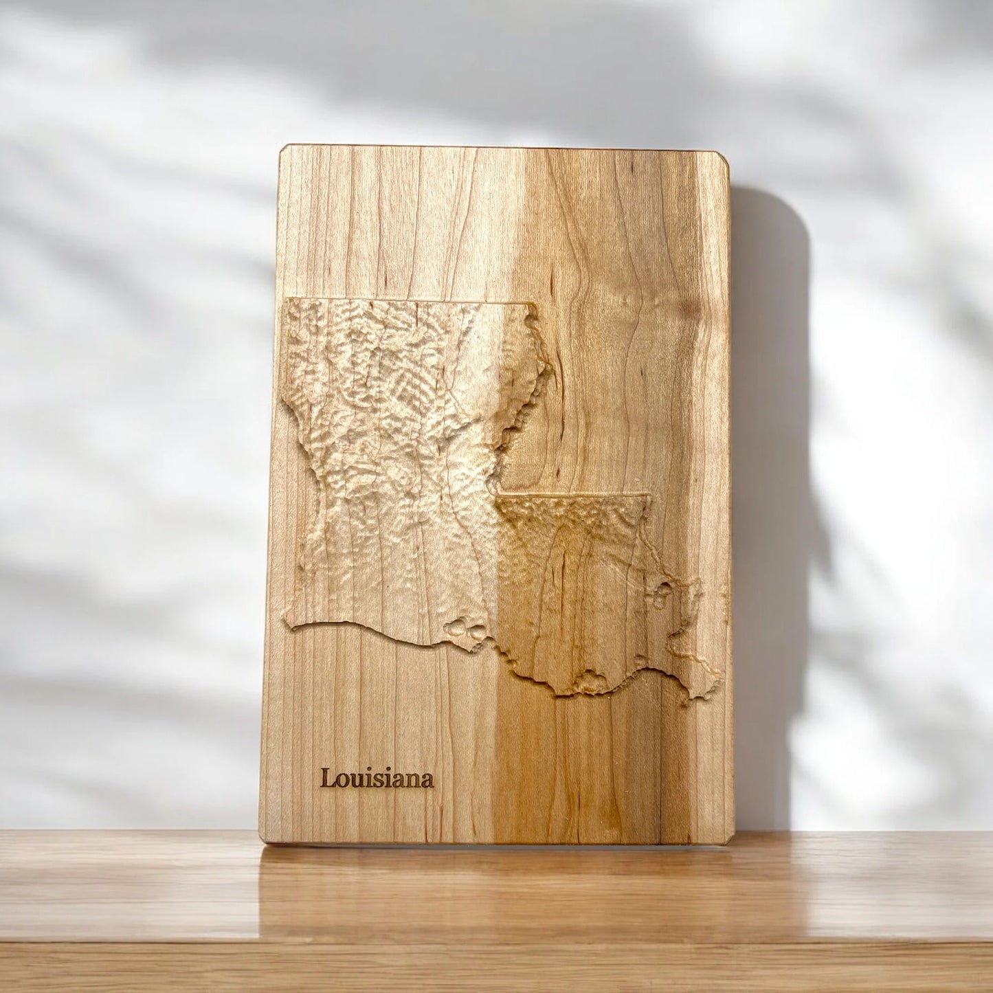 Wooden carved 3d map of Louisiana state on a white background