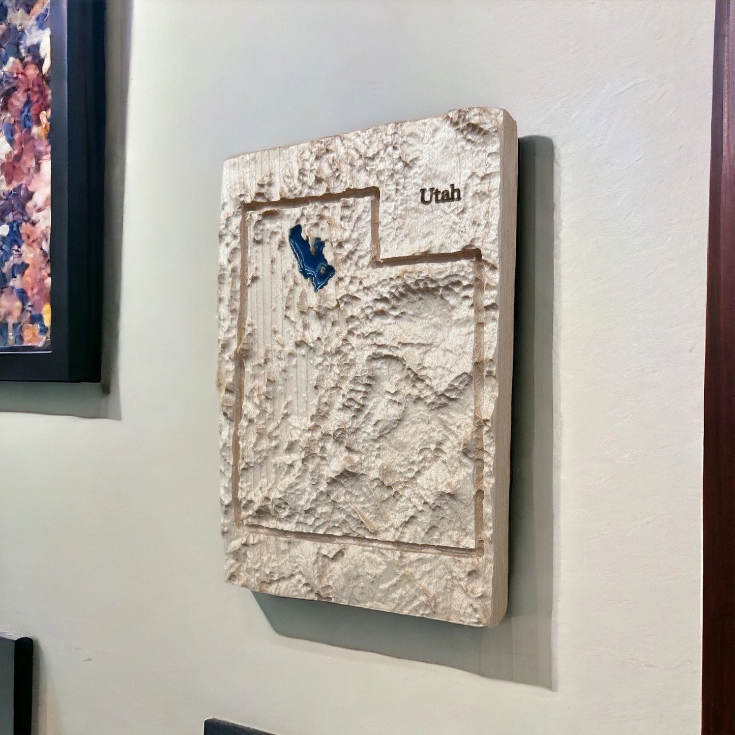 3D textured wall art of Utah with a blue accent of the great salt lake on a light gray wall.