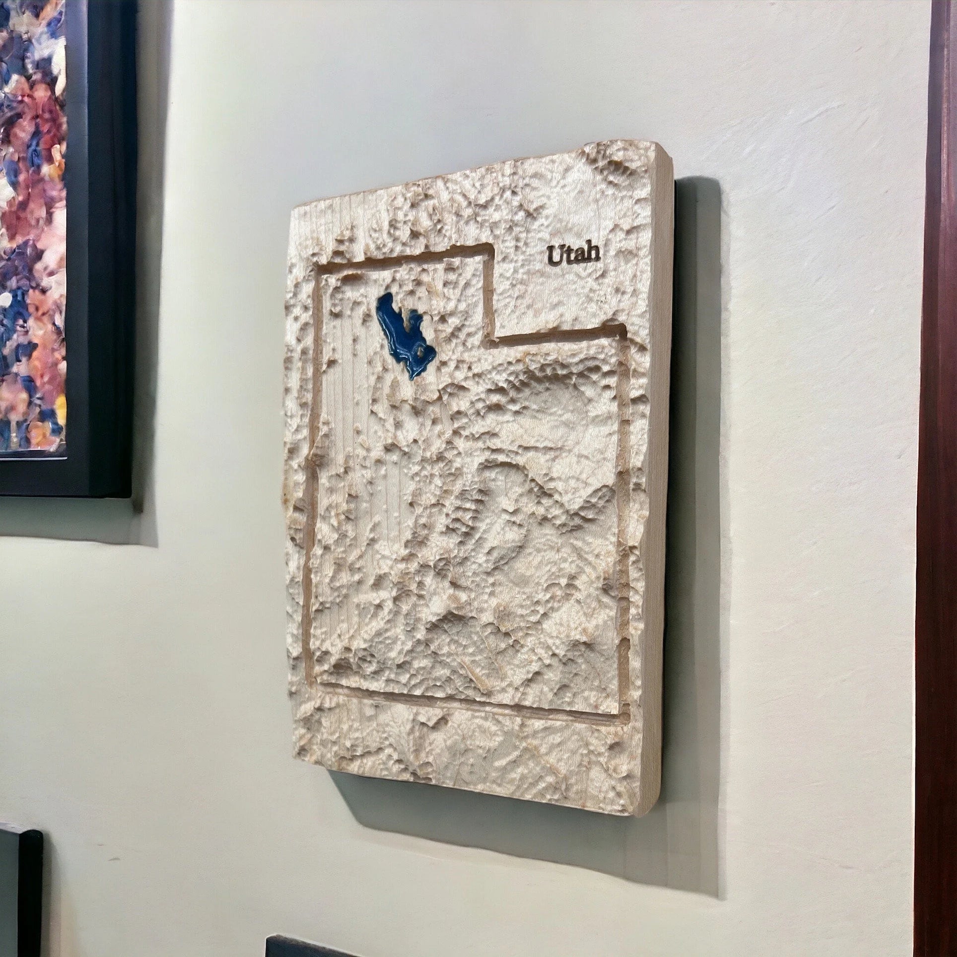 3D textured wall art of Utah with a blue accent of the great salt lake on a light gray wall.